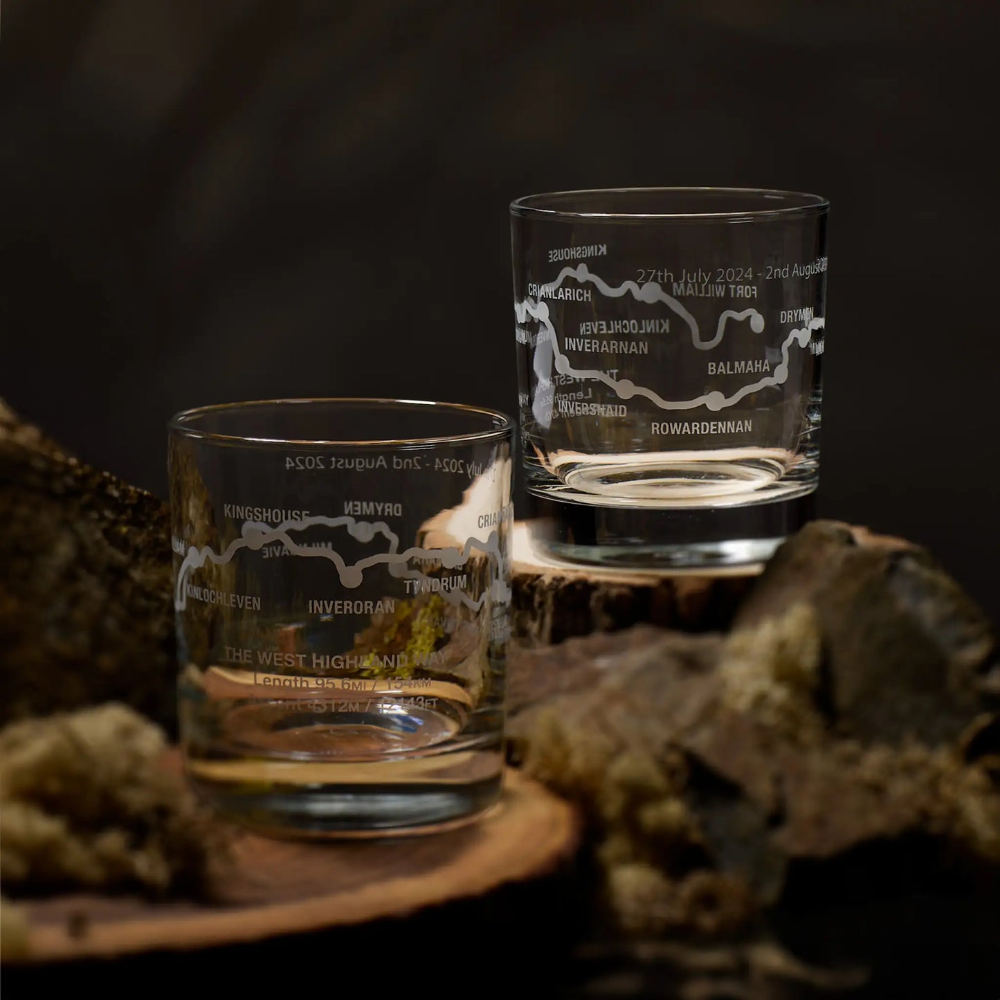 Two whisky glasses engraved with the West Highland Way route and distance