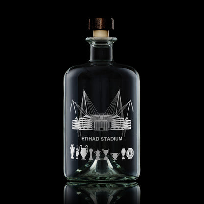 Glass decanter bottle engraved City of Manchesters football stadiums and nine trophies