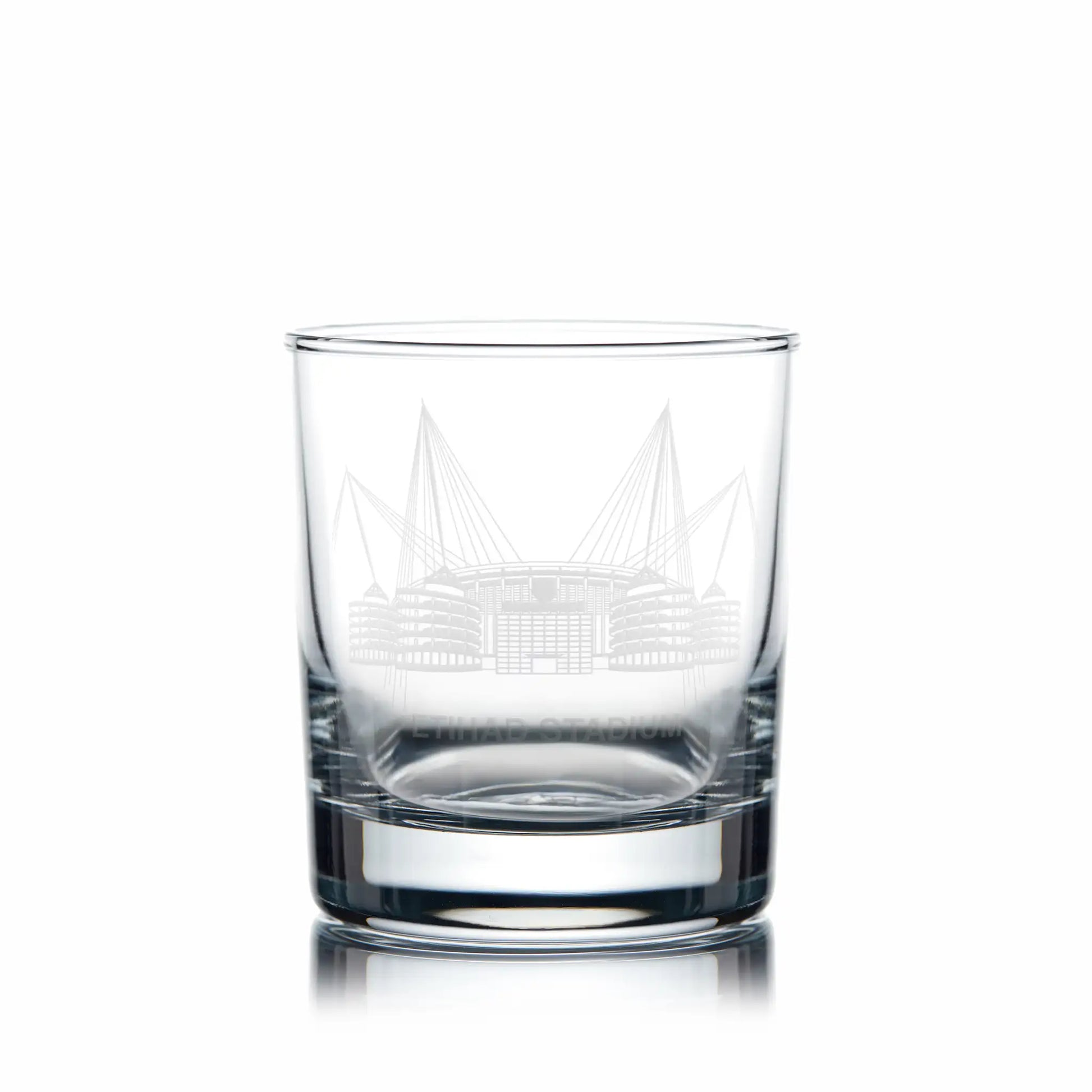 Whisky glass with engraved Etihad Stadium artwork and space for personalisation, photographed on a white background.