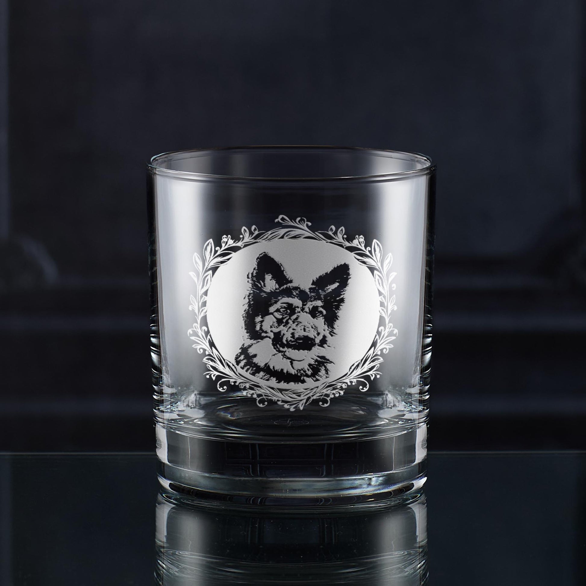 Engraved German Shepherd whisky glass showing a circular portrait framed by a leafy garland.