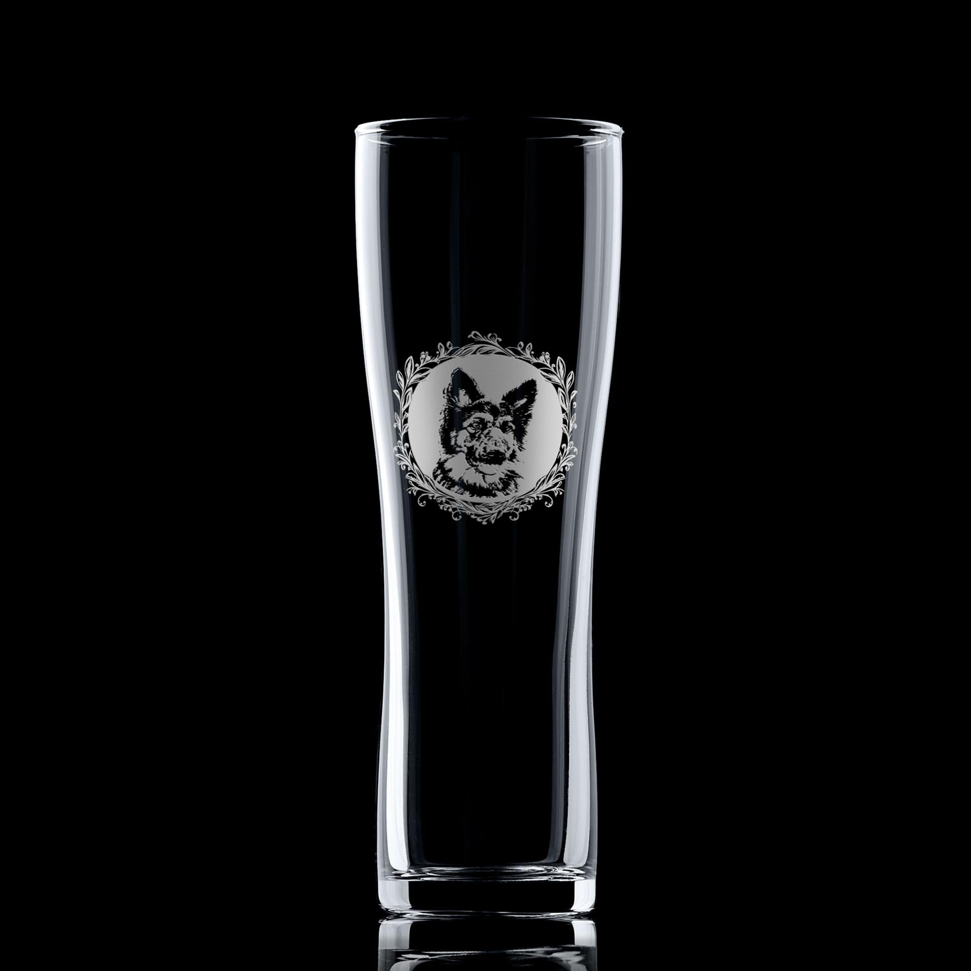 German Shepherd pint glass shown against a dark background, featuring a leafy garland portrait design.