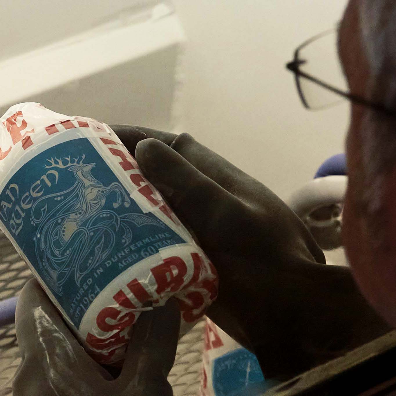 glass engraver sandblasting an apothecary decanter