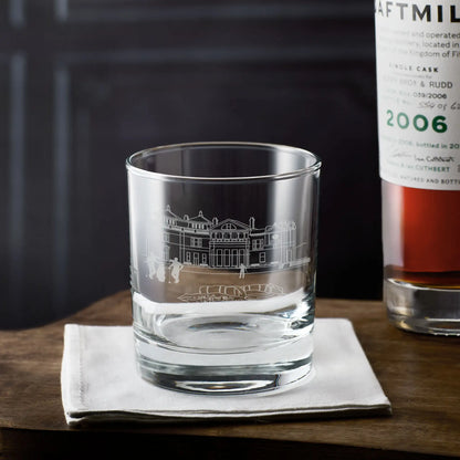 Engraved whisky glass with the Old Course clubhouse at St Andrews illustration next to a bottle of Daftmill whisky