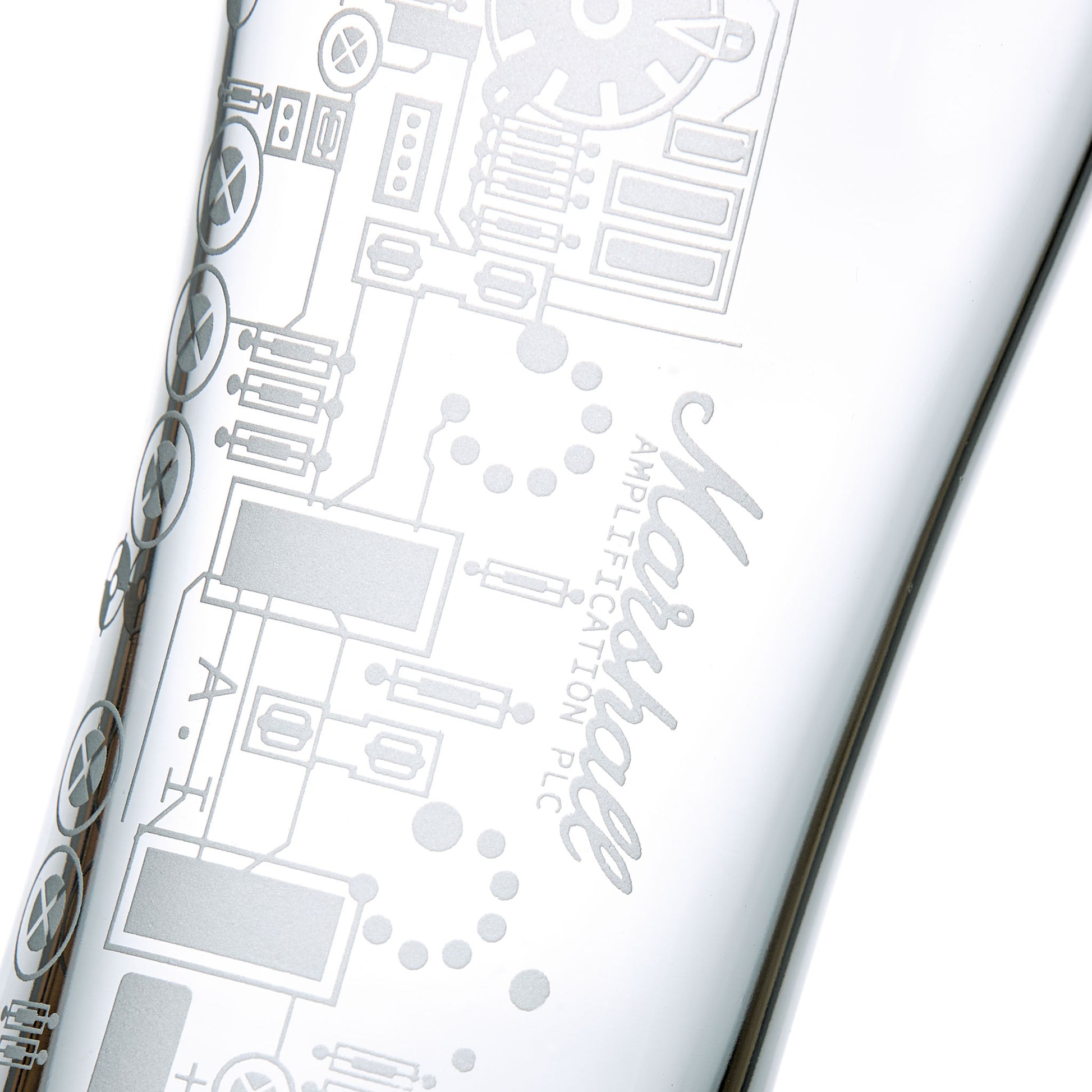 Detail of engraved pint glass featuring a circuit board on a white background
