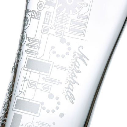 Detail of engraved pint glass featuring a circuit board on a white background