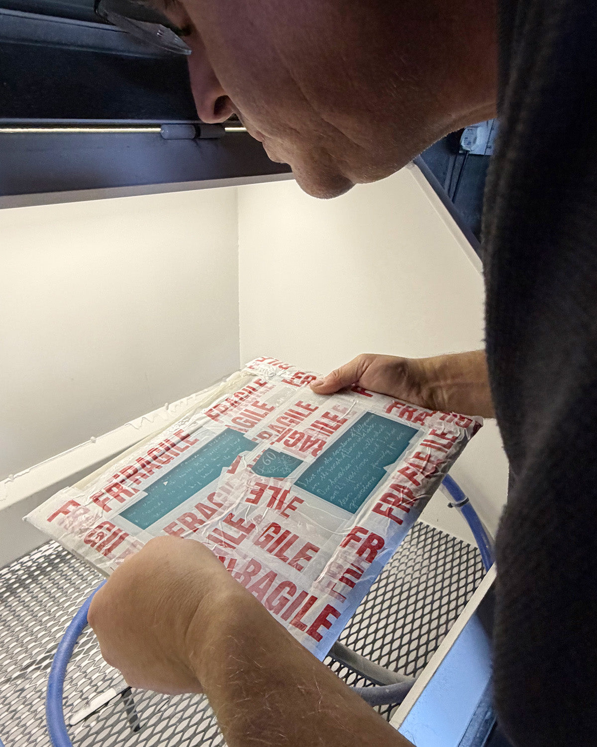 Original family handwriting being quality checked after sandblast engraved onto the glass