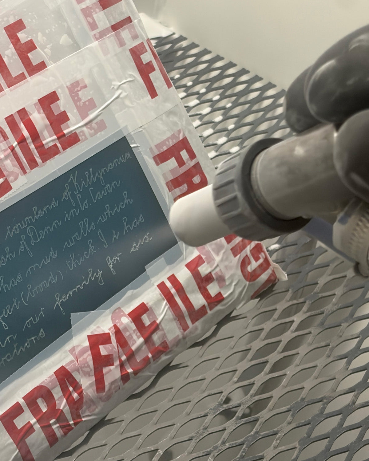 Original family handwriting being sandblast engraved onto the glass