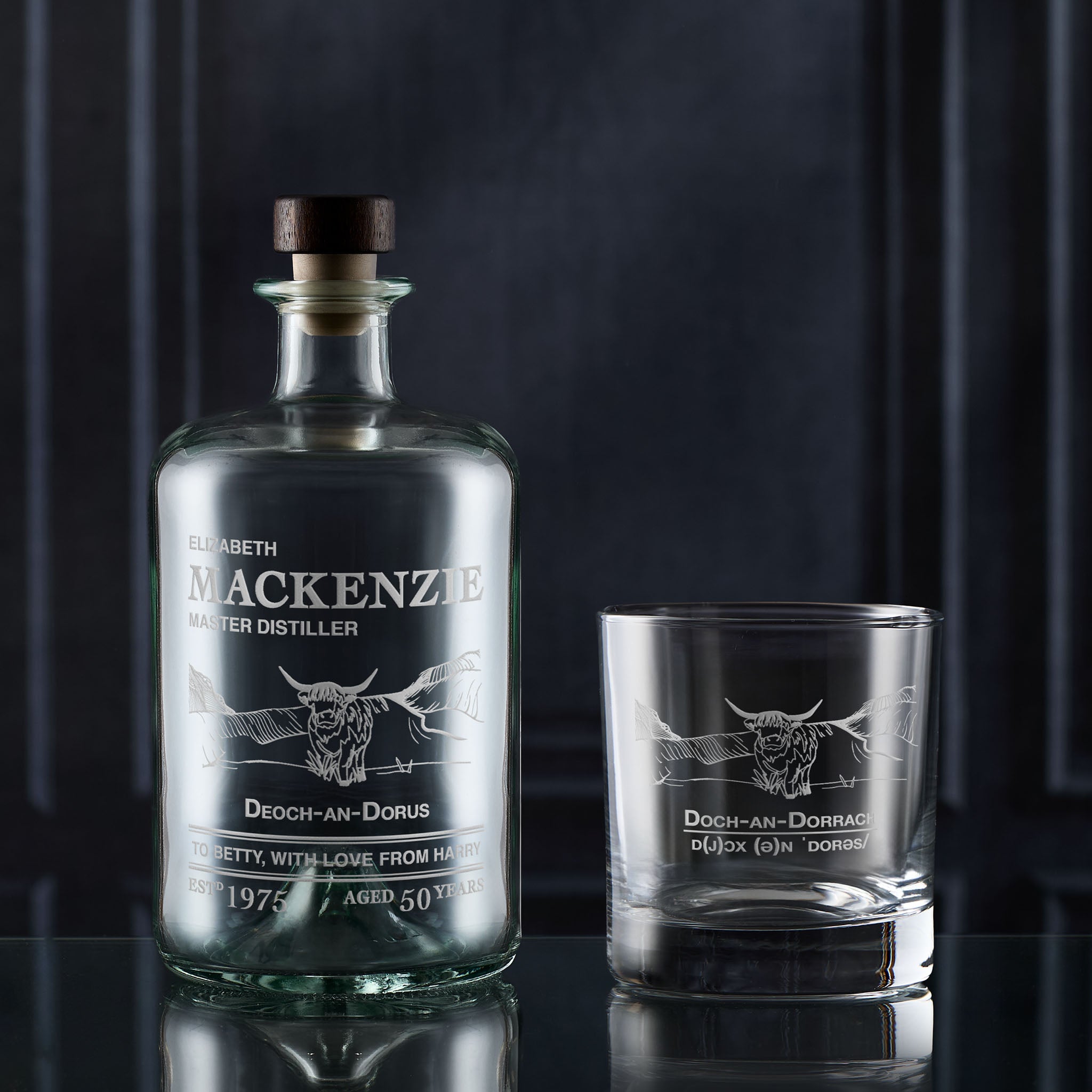 Decanter gift set includes a whisky bottle and glass with engraved highland cow design on a dark background
