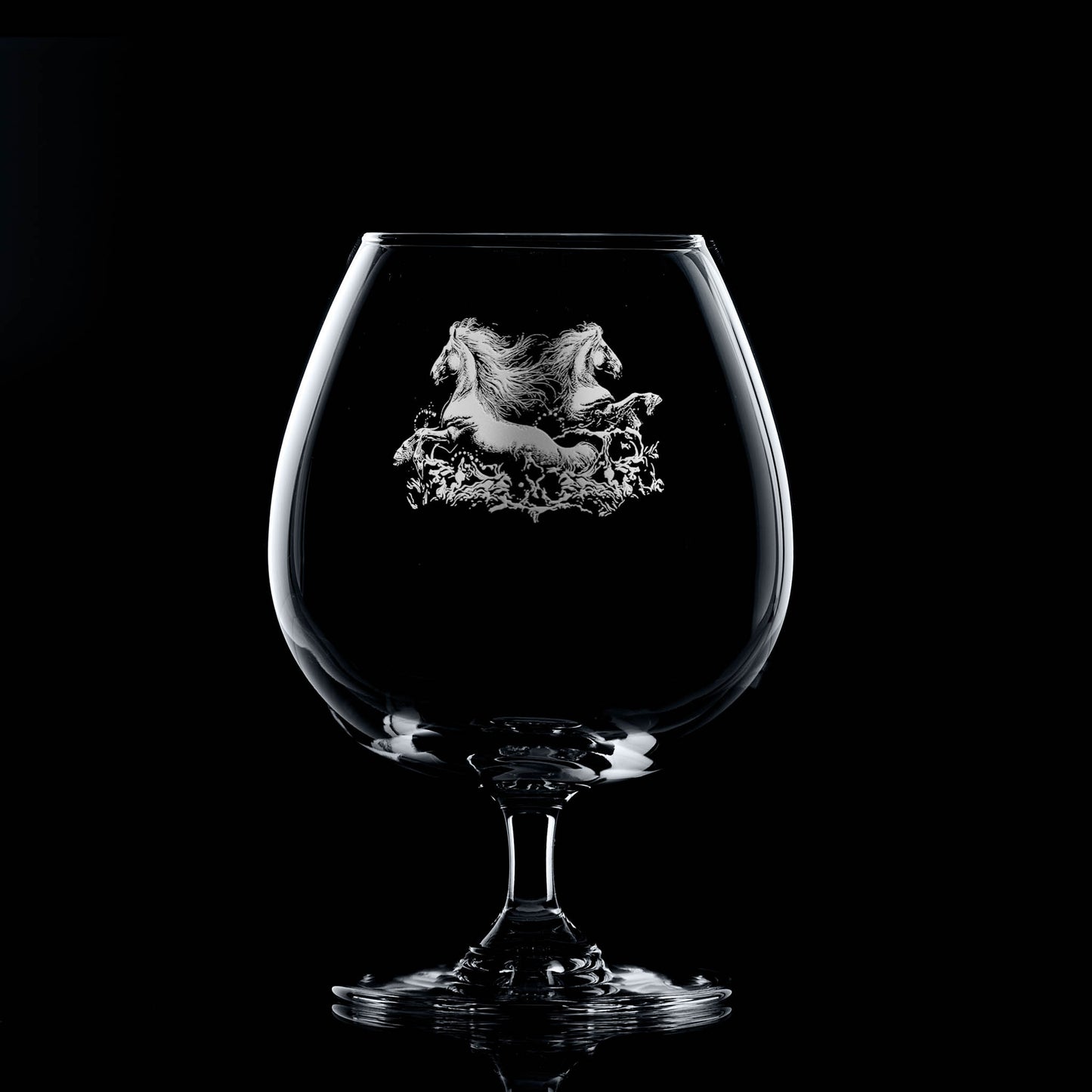 Brandy balloon glass engraved with two kelpies rising from water, with space for a message