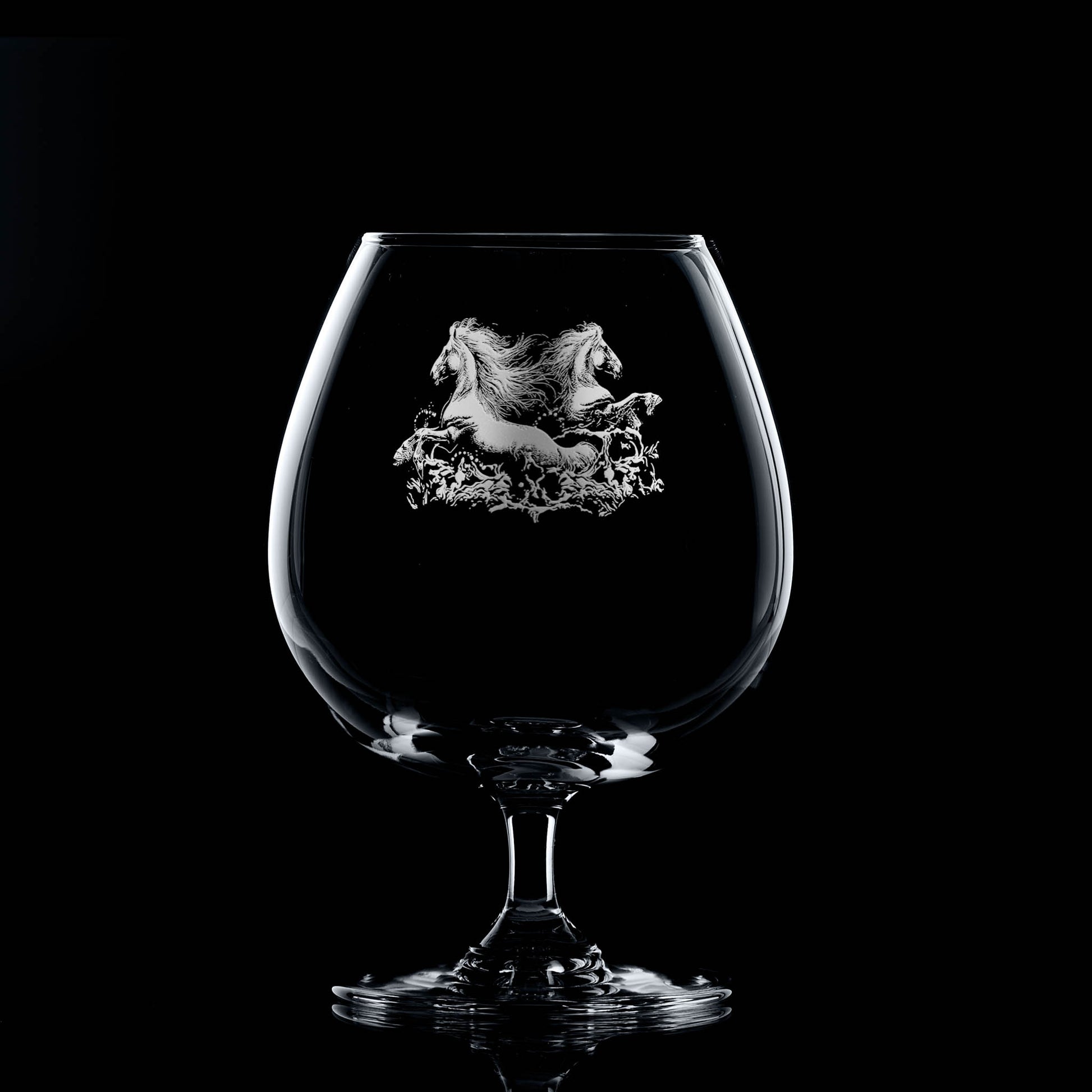 Brandy balloon glass engraved with two kelpies rising from water, with space for a message