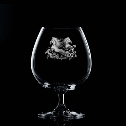 Brandy balloon glass engraved with two kelpies rising from water, with space for a message
