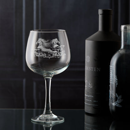 Gin glass engraved with two horses galloping through the water