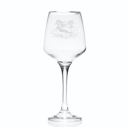Graceful wine glass with curved bowl and engraved mythical kelpie design on a white background