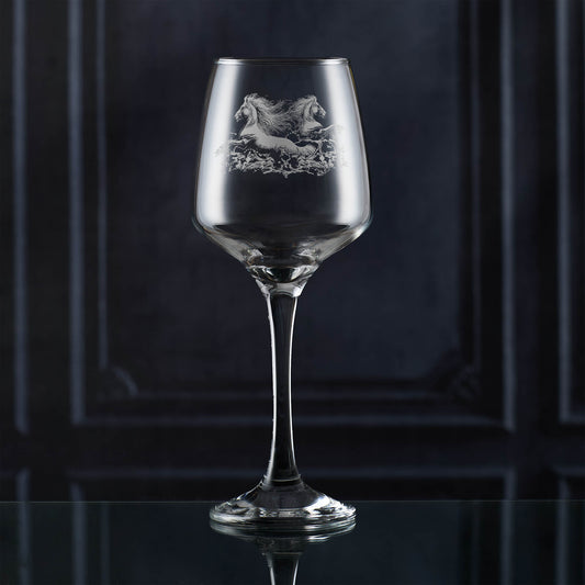 Wine glass with engraved horse design on a dark background