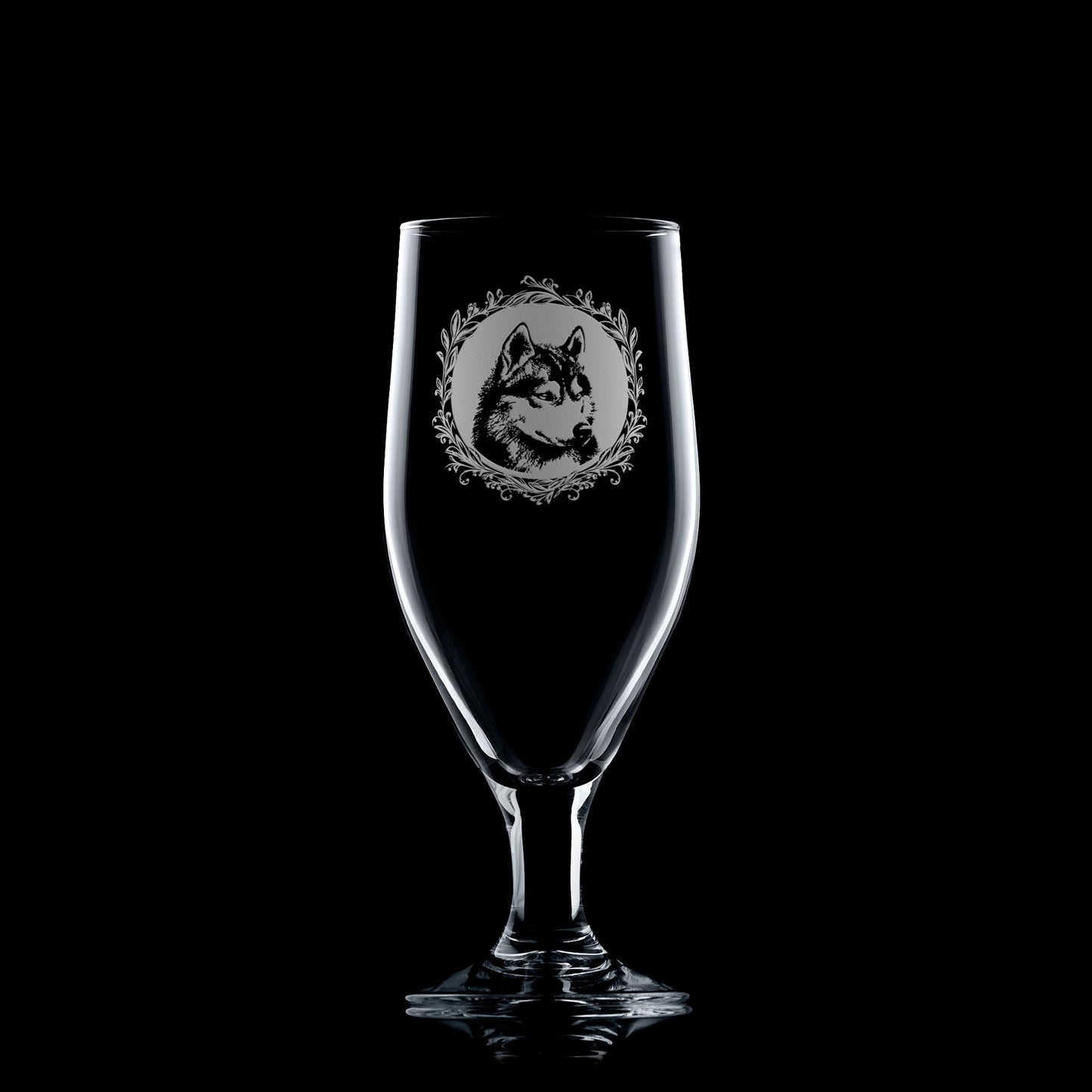 Clear glass with engraved wolf design on a black background