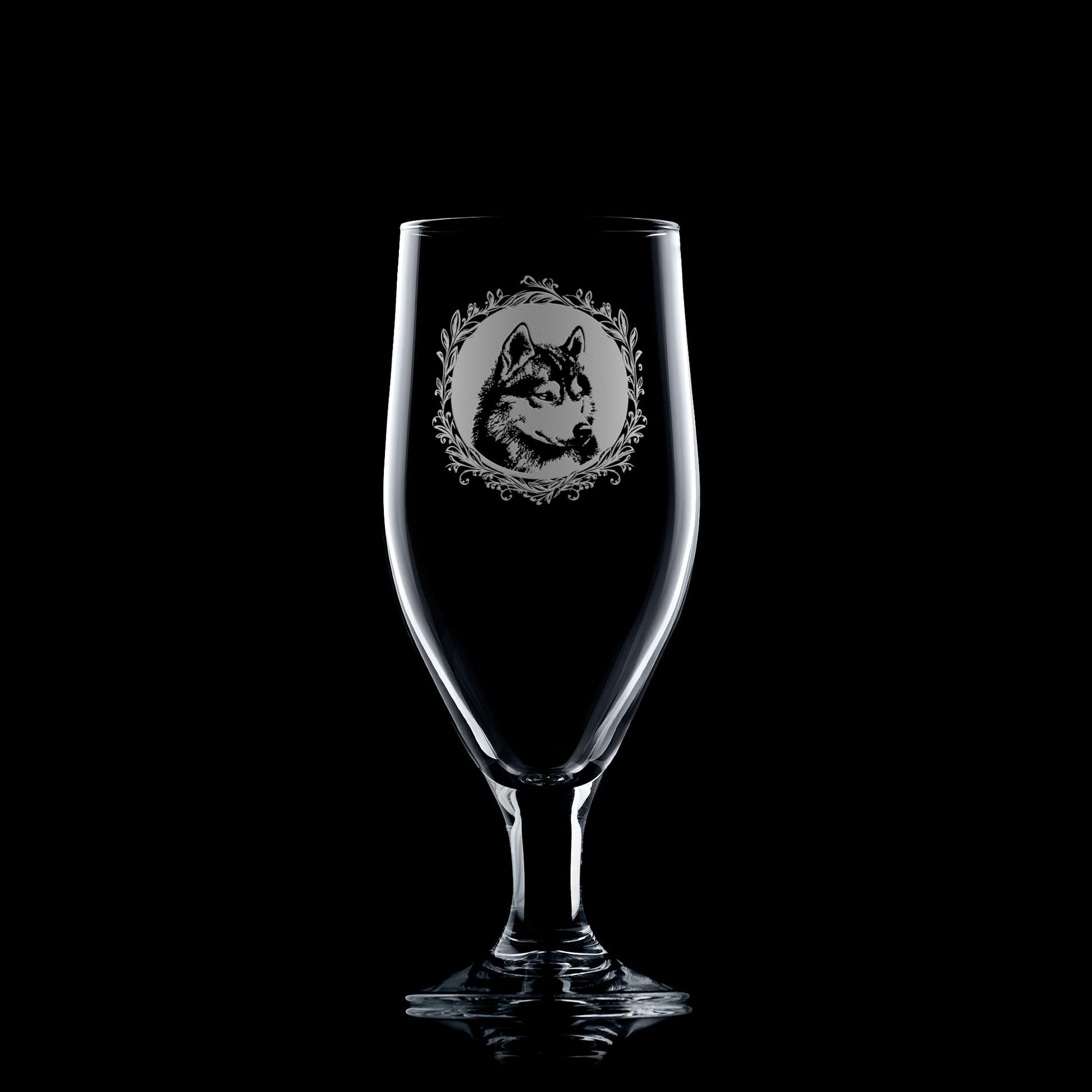 Clear glass with engraved wolf design on a black background