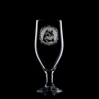 Clear glass with engraved wolf design on a black background