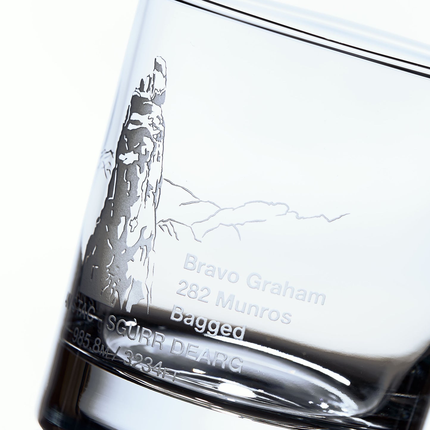 close up detail of sandblast engraving of sgurr dearg cuillin mountain isle of skye on a whisky tumbler