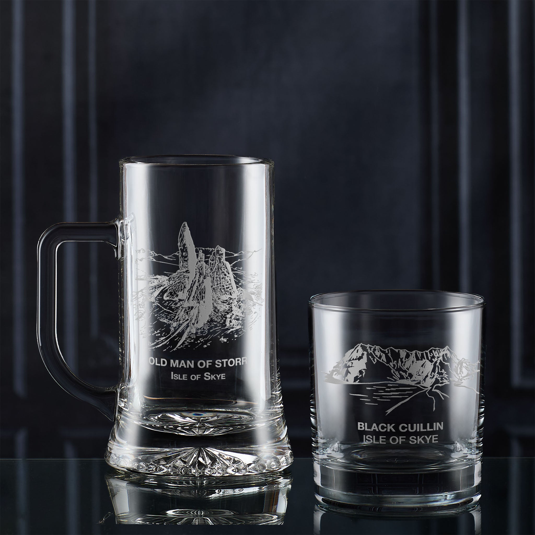 Glass tankard and whisky glass with Isle of Skye landscape designs and text on a dark background