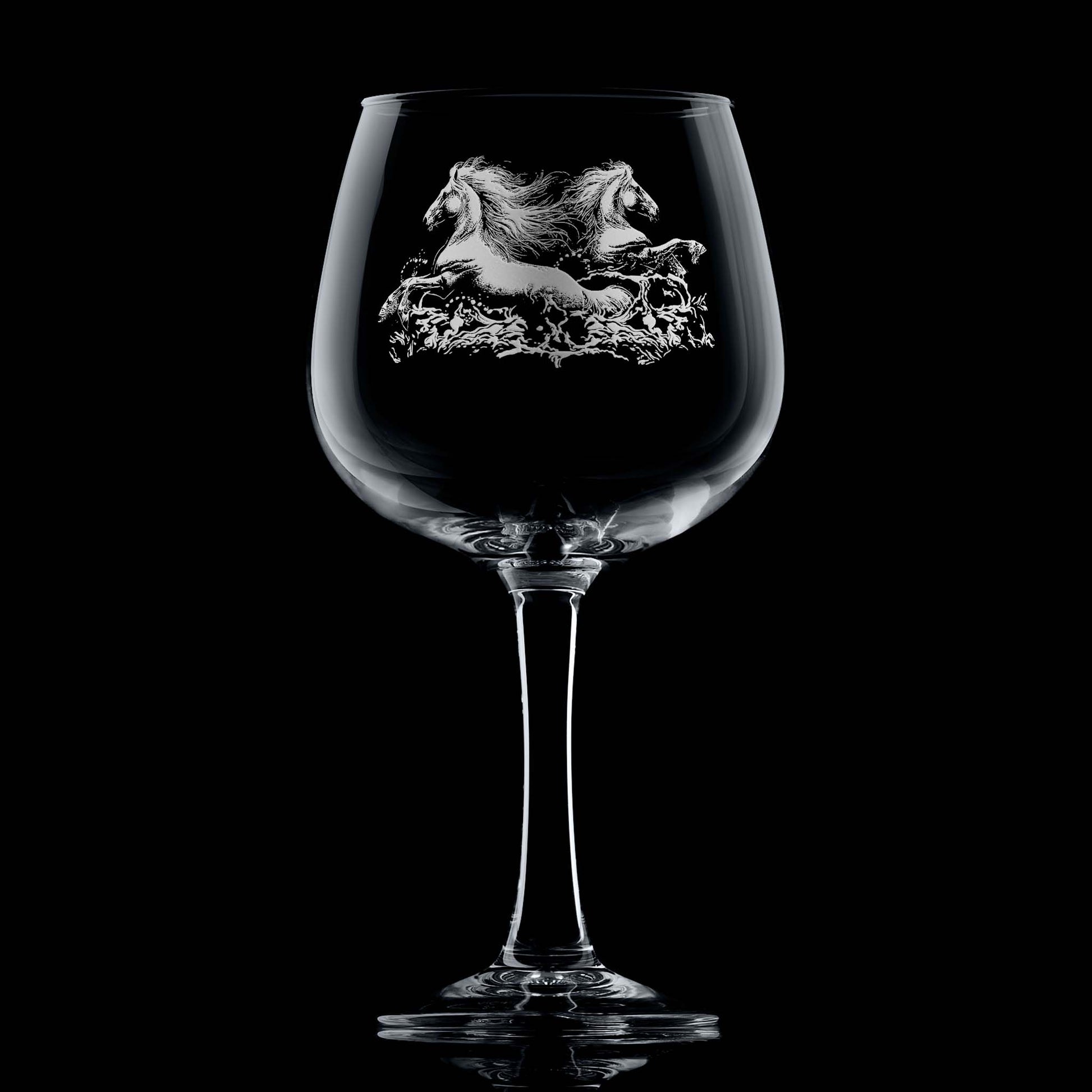 Twin kelpies rising from crashing waves on engraved gin glass with space for a message