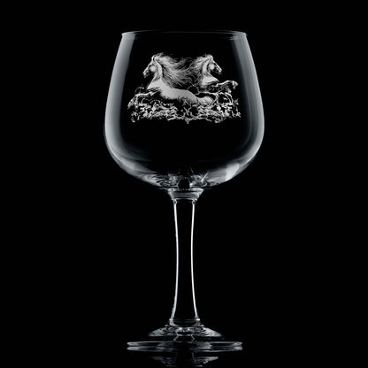 Twin kelpies rising from crashing waves on engraved gin glass with space for a message
