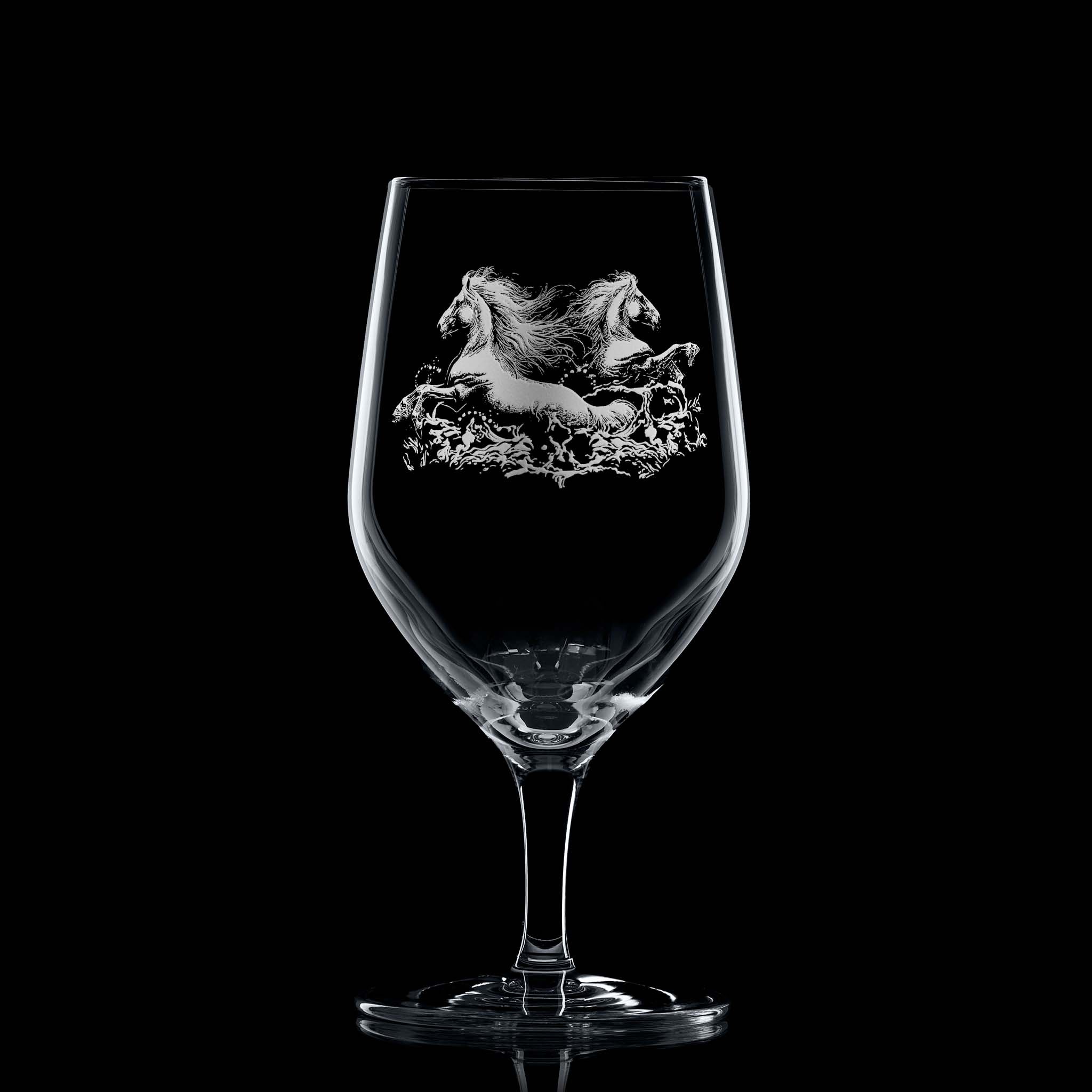 Glass on black background to highlight engraving: Elegant mineral water glass with engraved twin kelpies and wave detail