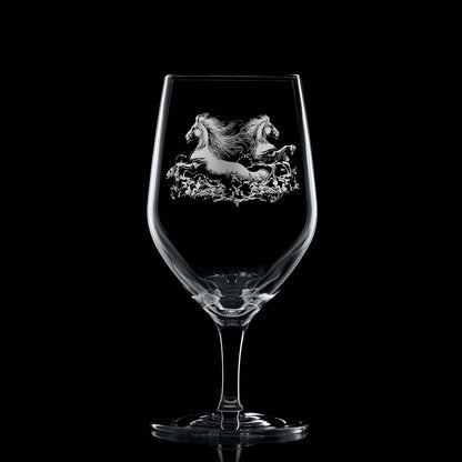 Glass on black background to highlight engraving: Elegant mineral water glass with engraved twin kelpies and wave detail