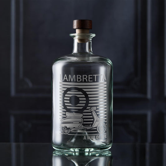 Clear glass apothecary bottle with a vinatge Lambretta scooter on a dark background