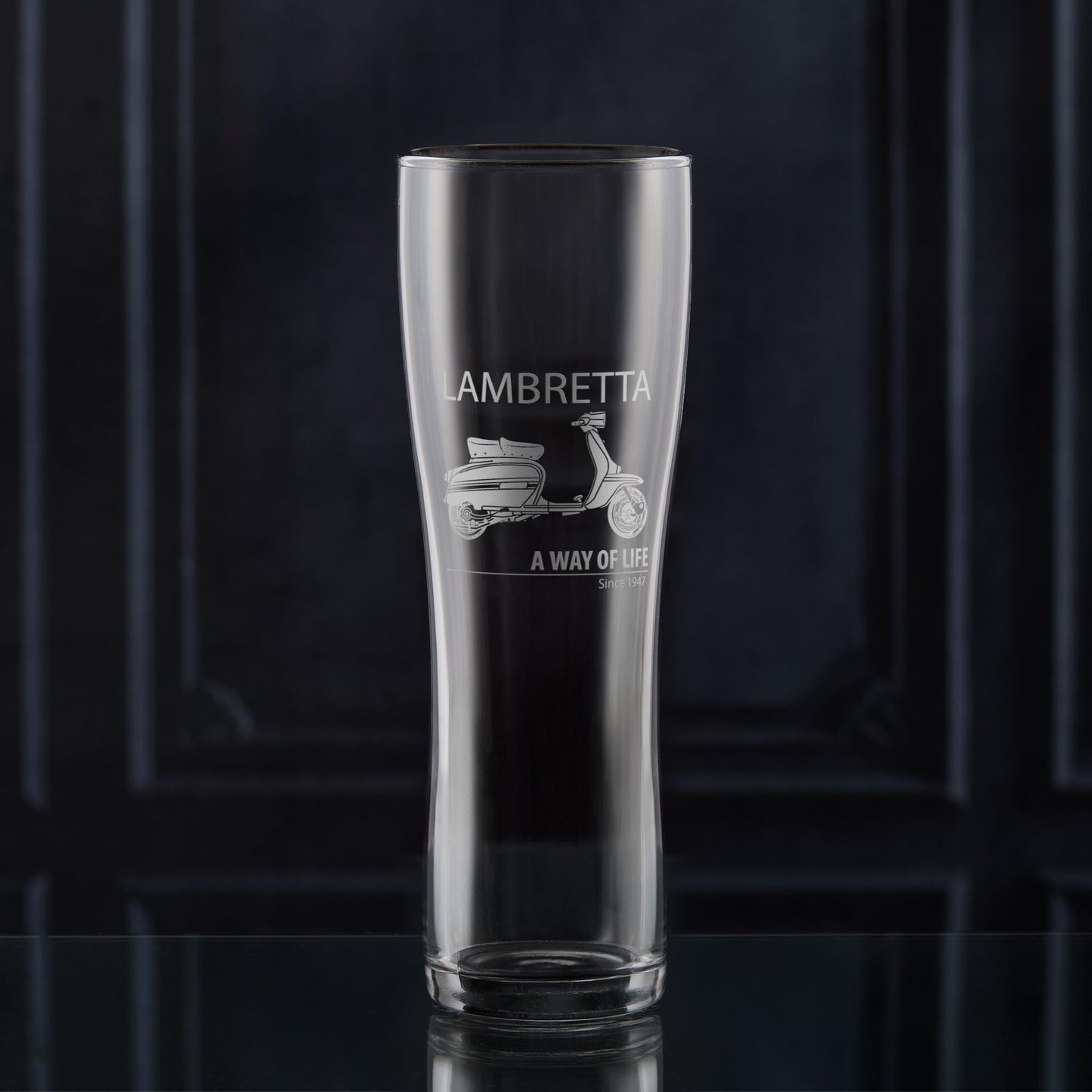 Engraved Lambretta GP pint glass with side-view scooter and “A Way of Life Since 1947” inscription, styled with warm lighting for contrast.