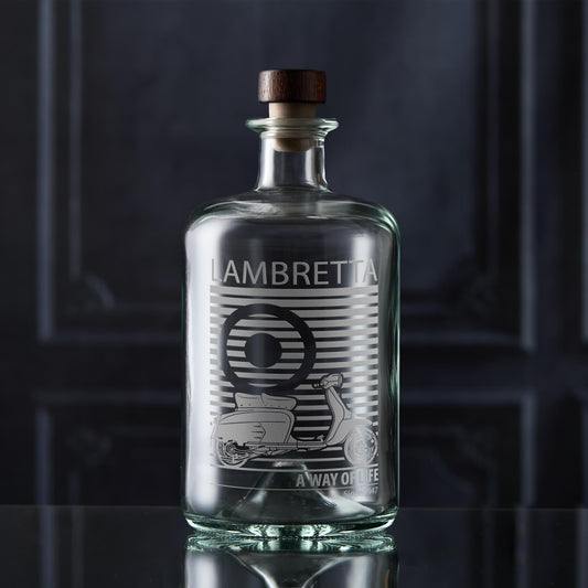 Clear glass lambretta SX200 decanter with wooden cap on a dark background