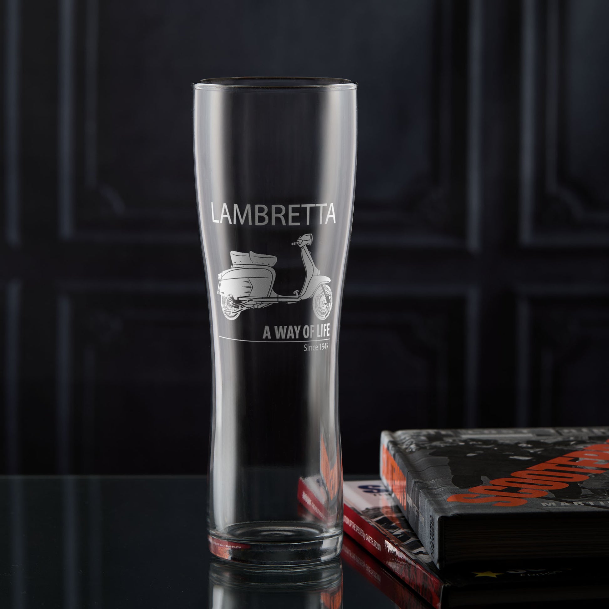 Pint glass engraved with a Lambretta SX200 scooter and 'A Way of Life' text on a dark background