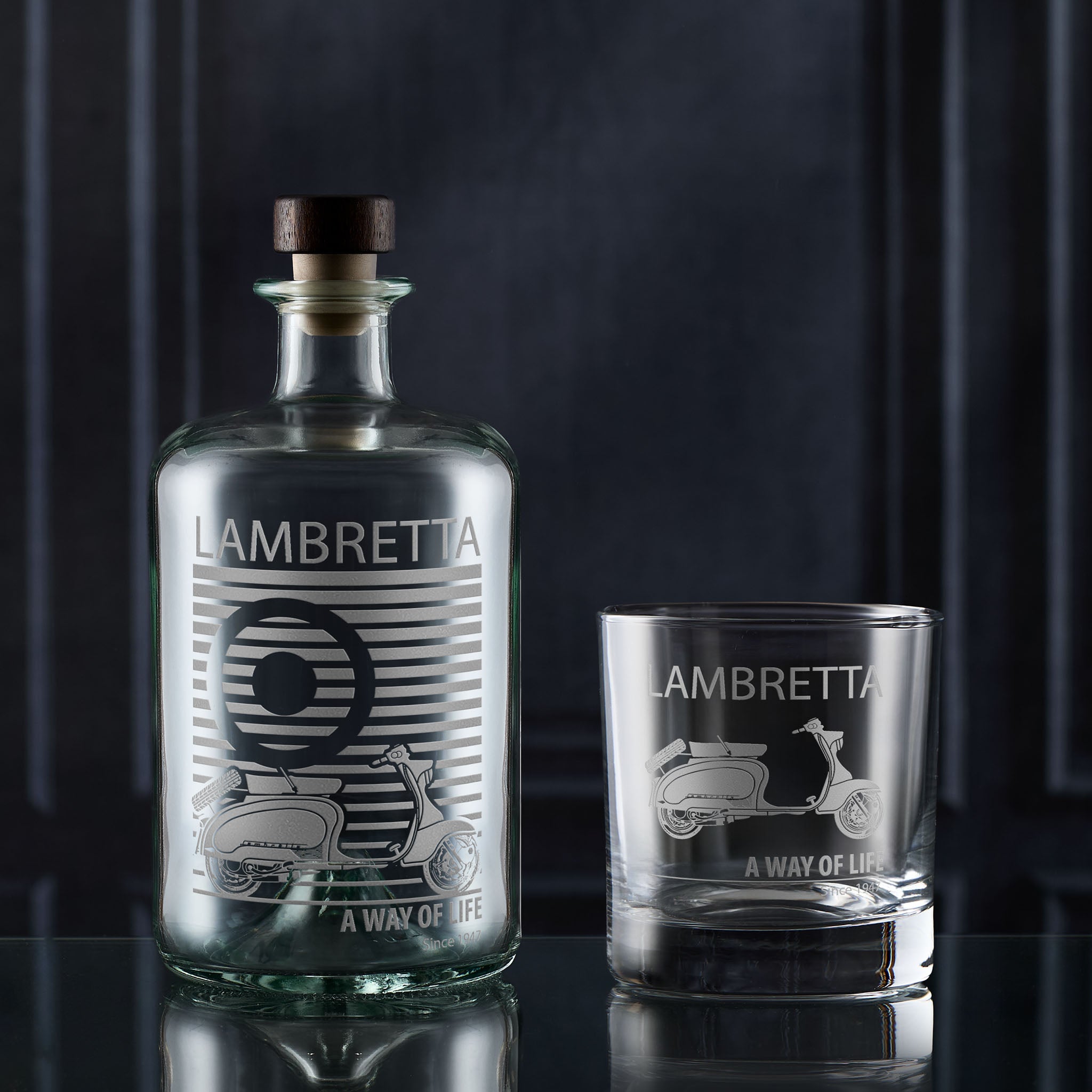 Lambretta mod target bottle and engraved scooter glass on a dark background