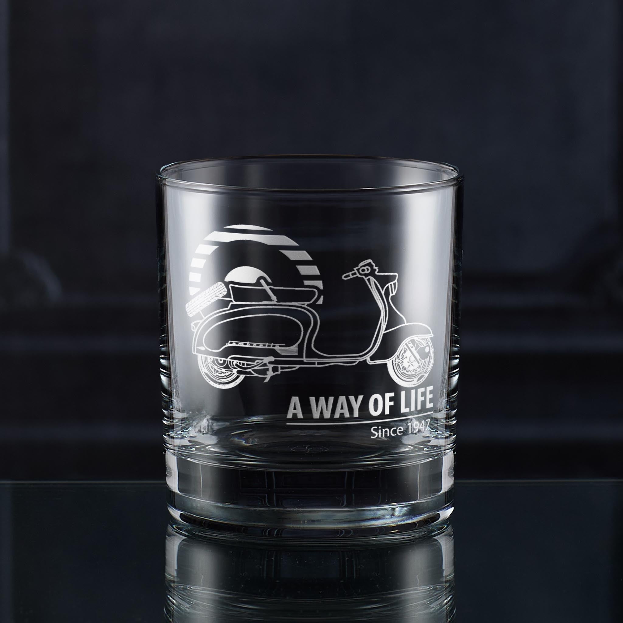 Clear glass whiskey tumbler with scooter design and 'A Way of Life' text on a dark background