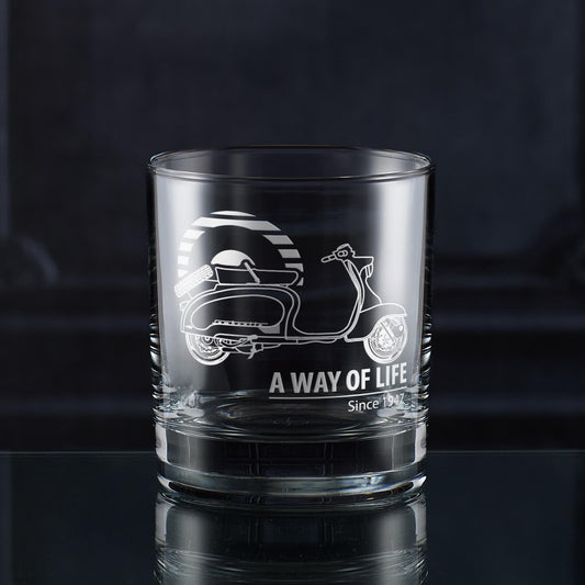 Clear glass whiskey tumbler with scooter design and 'A Way of Life' text on a dark background