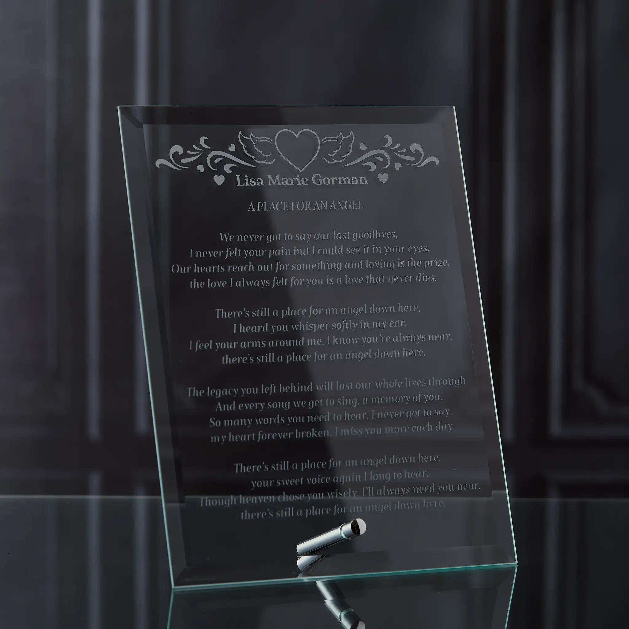 Glass plaque with engraved poem and hearts design on a dark background