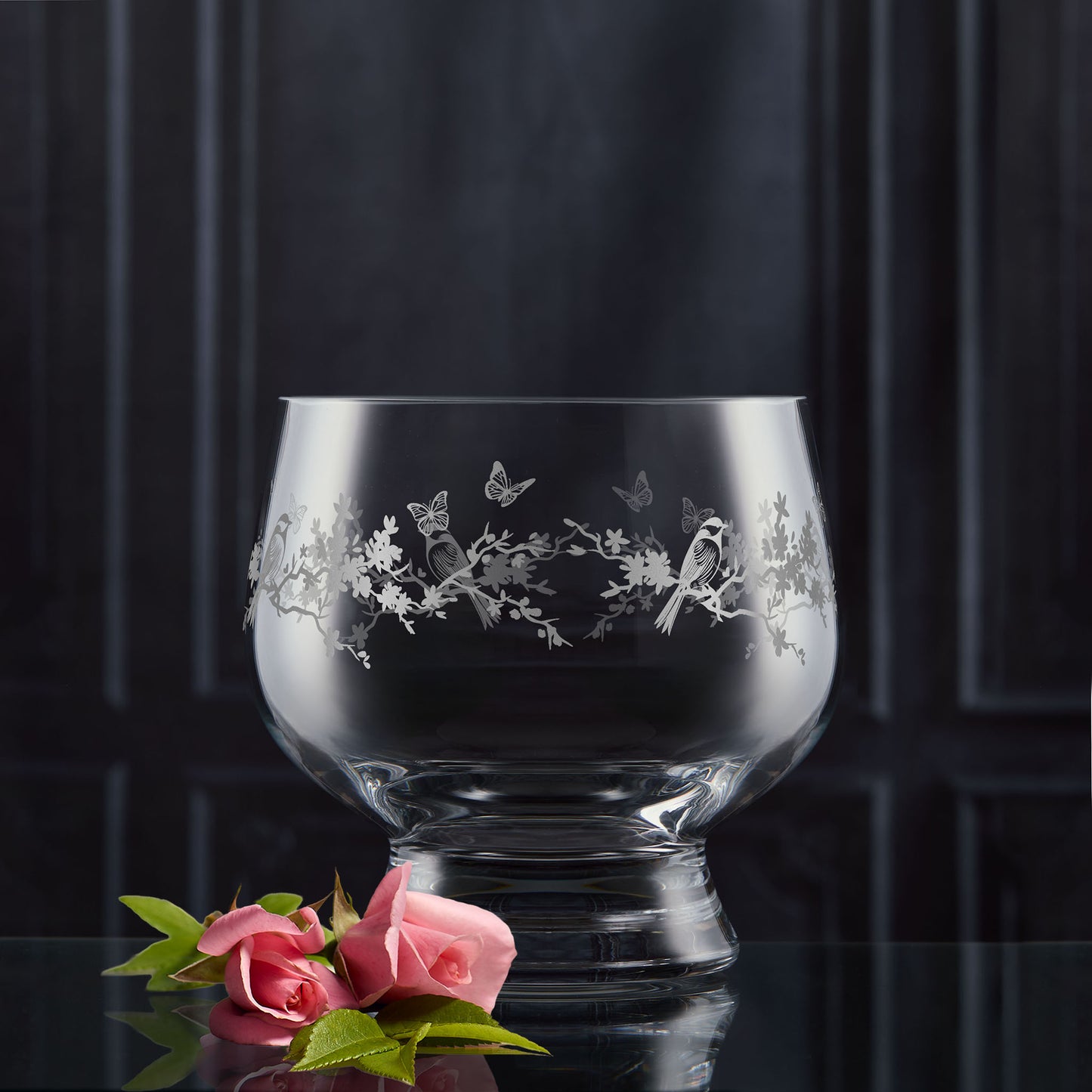 Decorative presentation bowl with flowers and garden birds engraving on a dark background