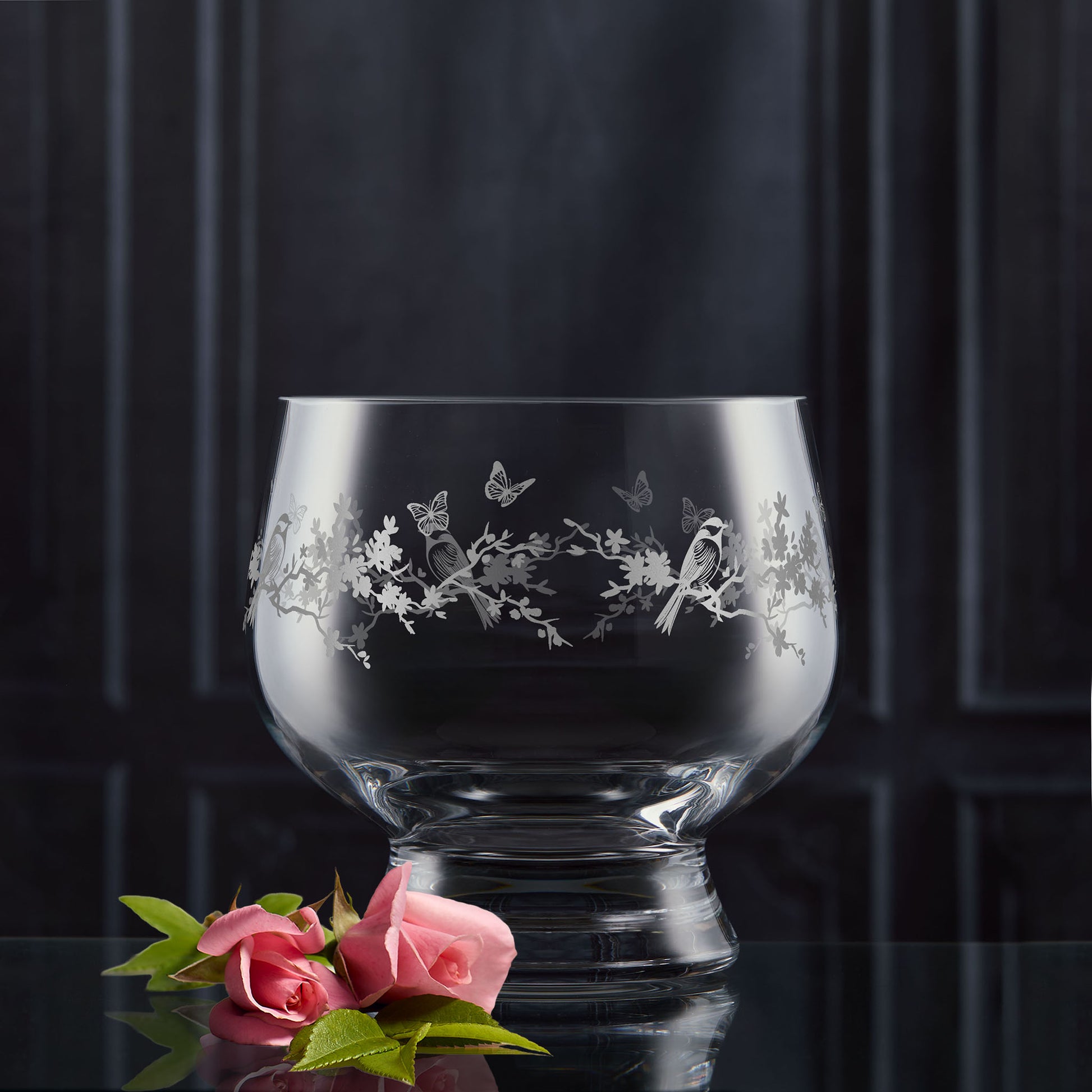 Decorative presentation bowl with flowers and garden birds engraving on a dark background