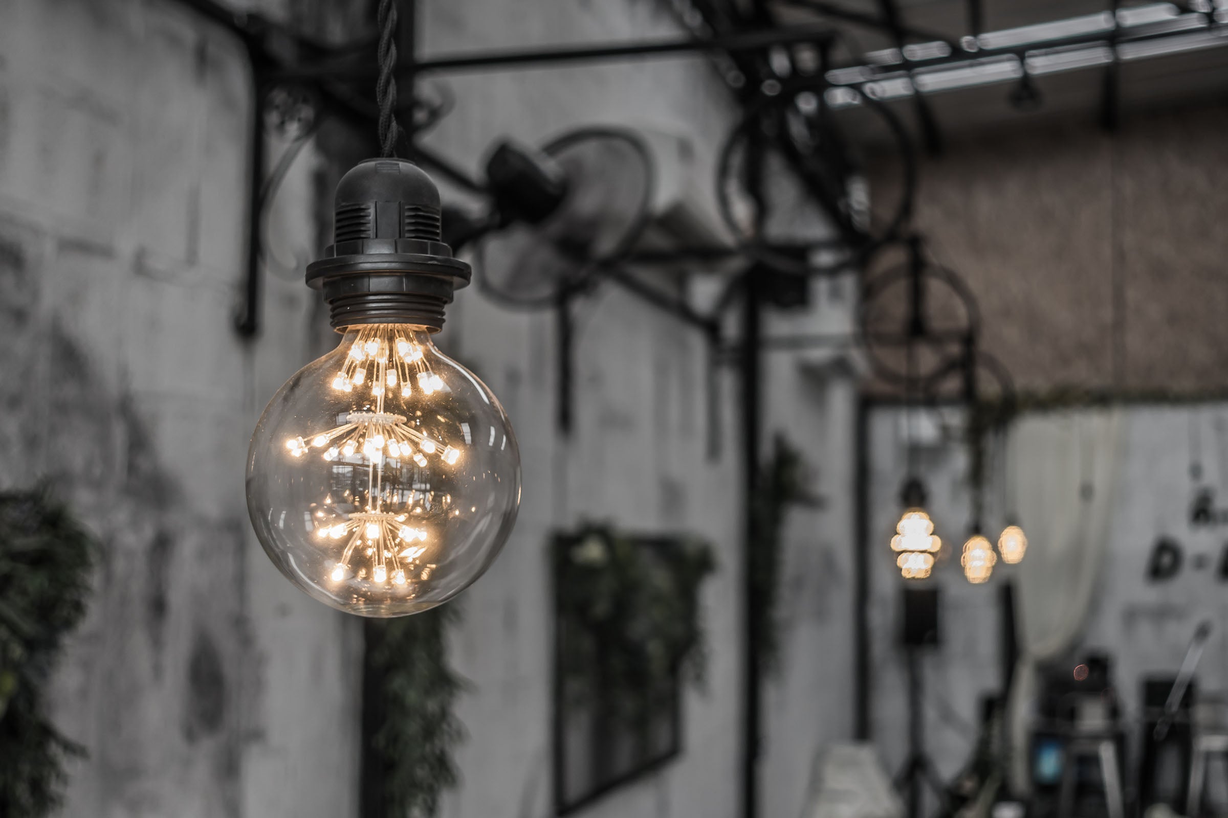 Vintage-style light bulb hanging against a blurred background