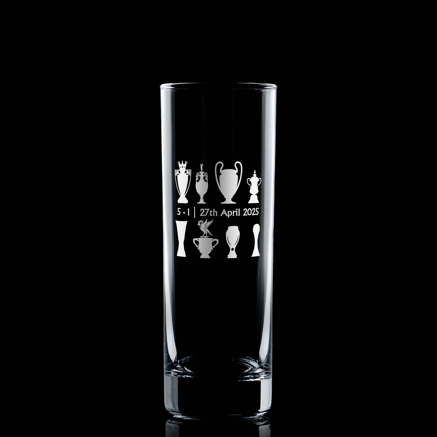 Front-facing engraved highball glass with championship trophy design and Bella the Liver Bird, photographed on black background