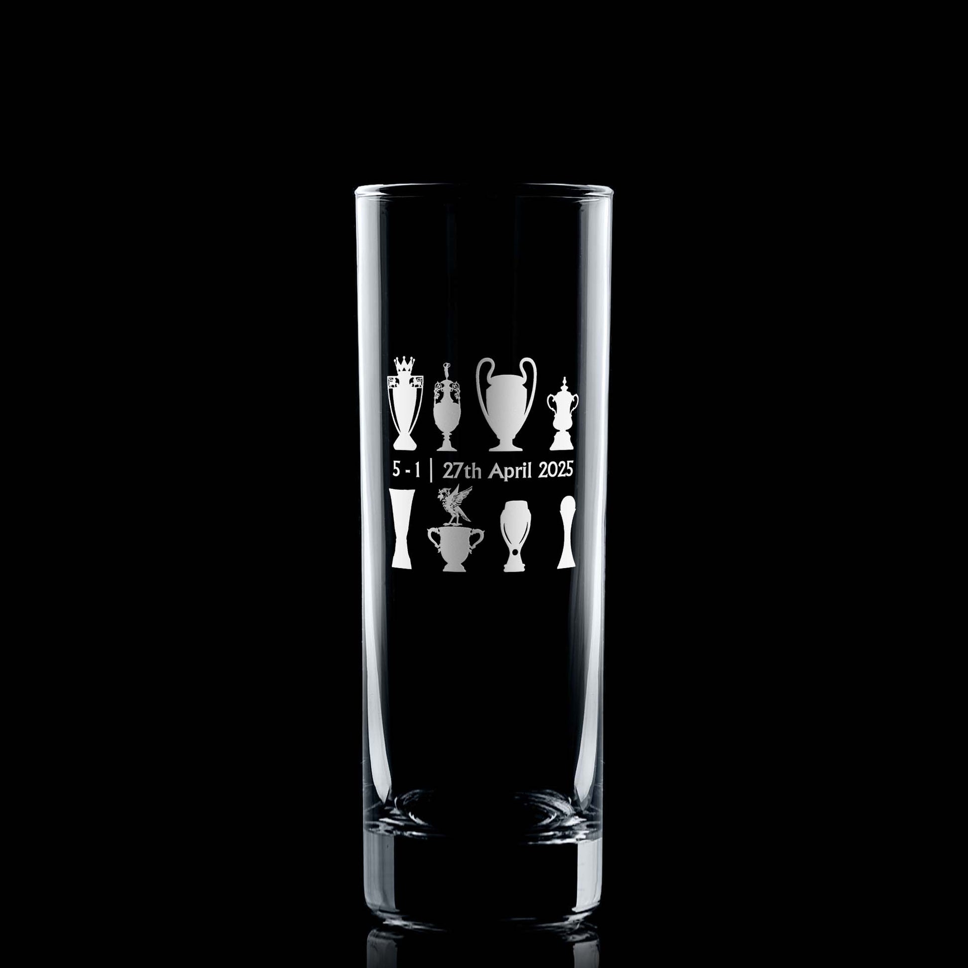 Front-facing engraved highball glass with championship trophy design and Bella the Liver Bird, photographed on black background