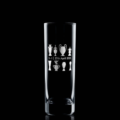 Front-facing engraved highball glass with championship trophy design and Bella the Liver Bird, photographed on black background