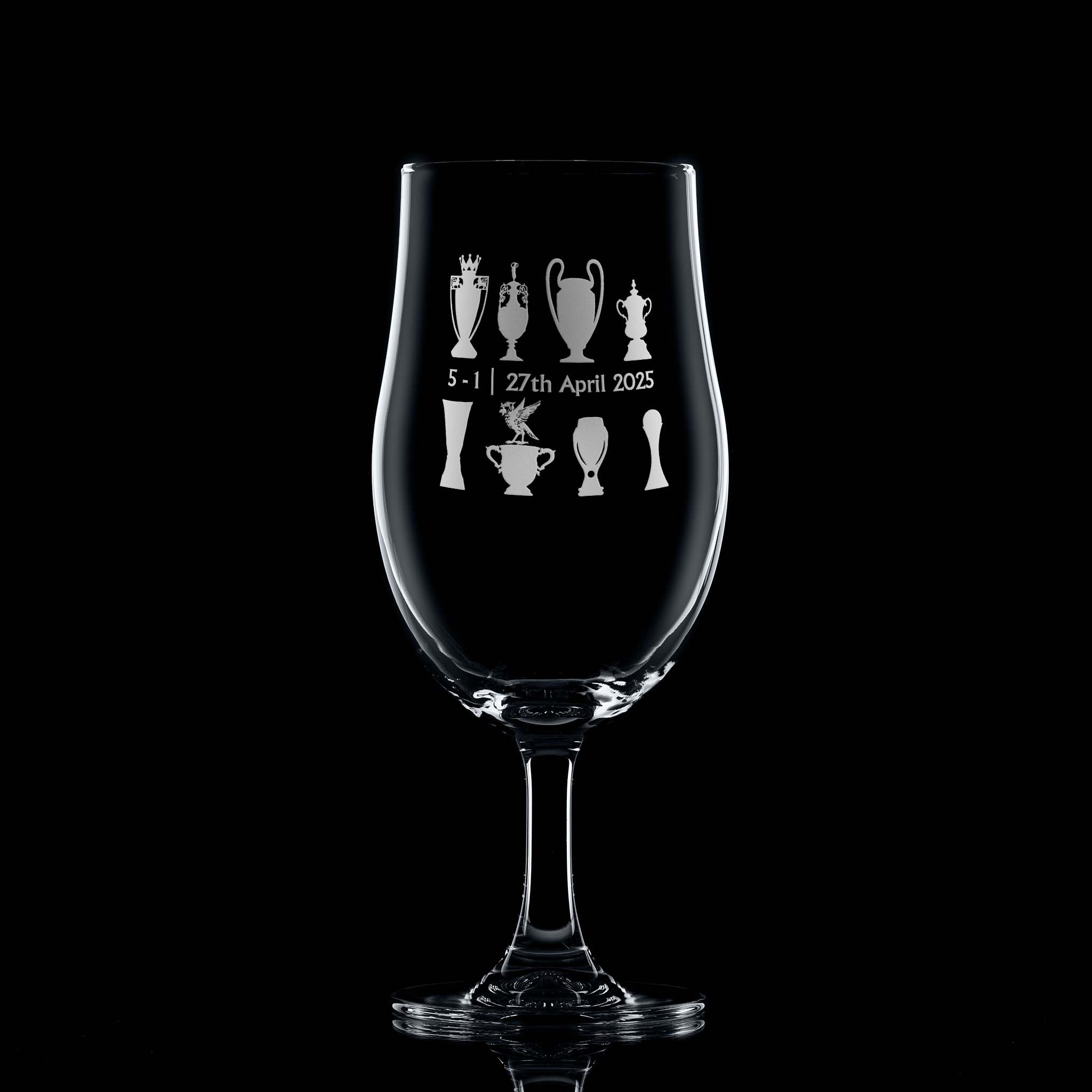 Front-facing engraved stemmed beer glass with two rows of trophies and Bella the Liverbird, on black background