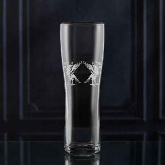 Engraved pint glass featuring two Liver Bird–inspired designs, Bella and Bertie, shown on a dark background.