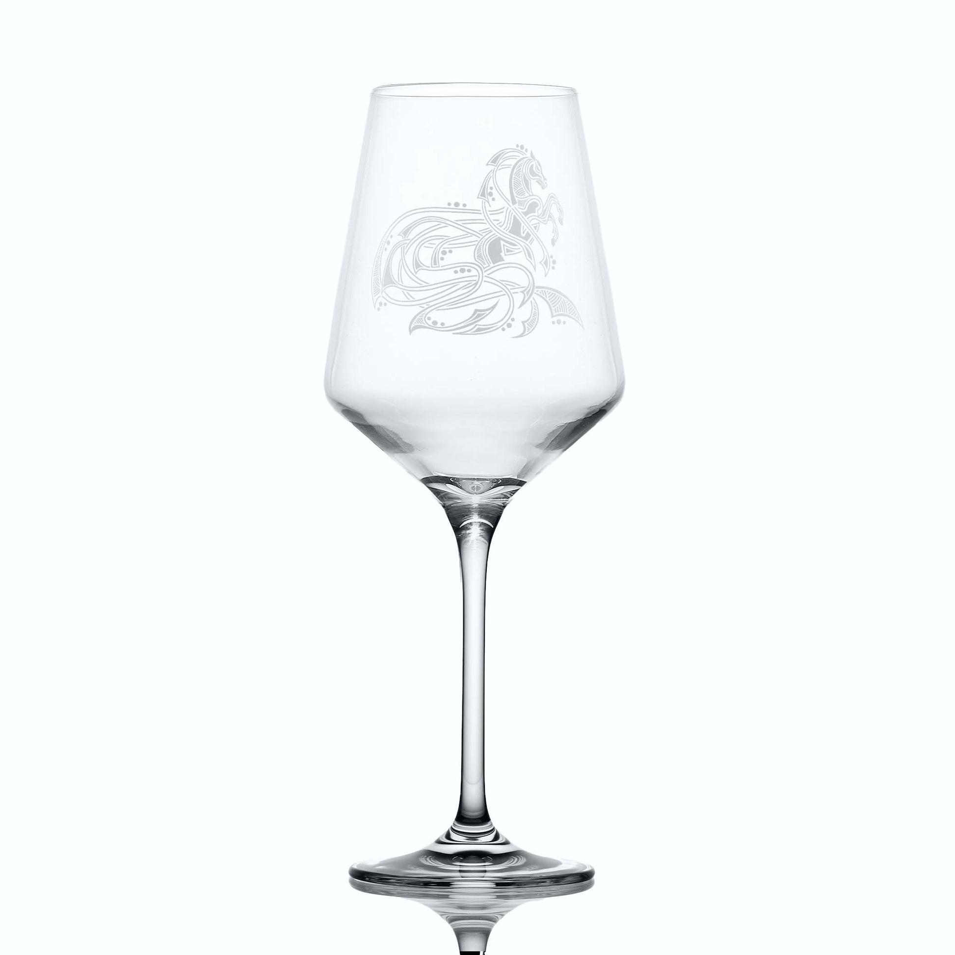 Clear wine glass with equestrian etching on a white background