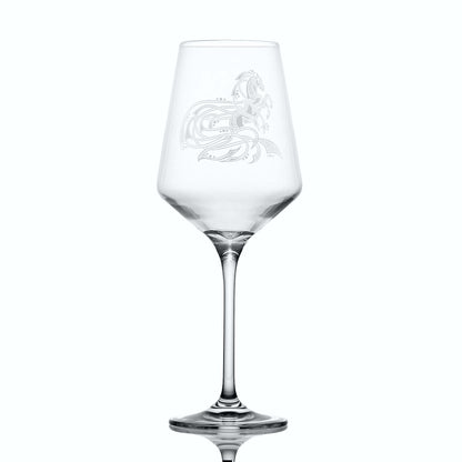 Clear wine glass with equestrian etching on a white background