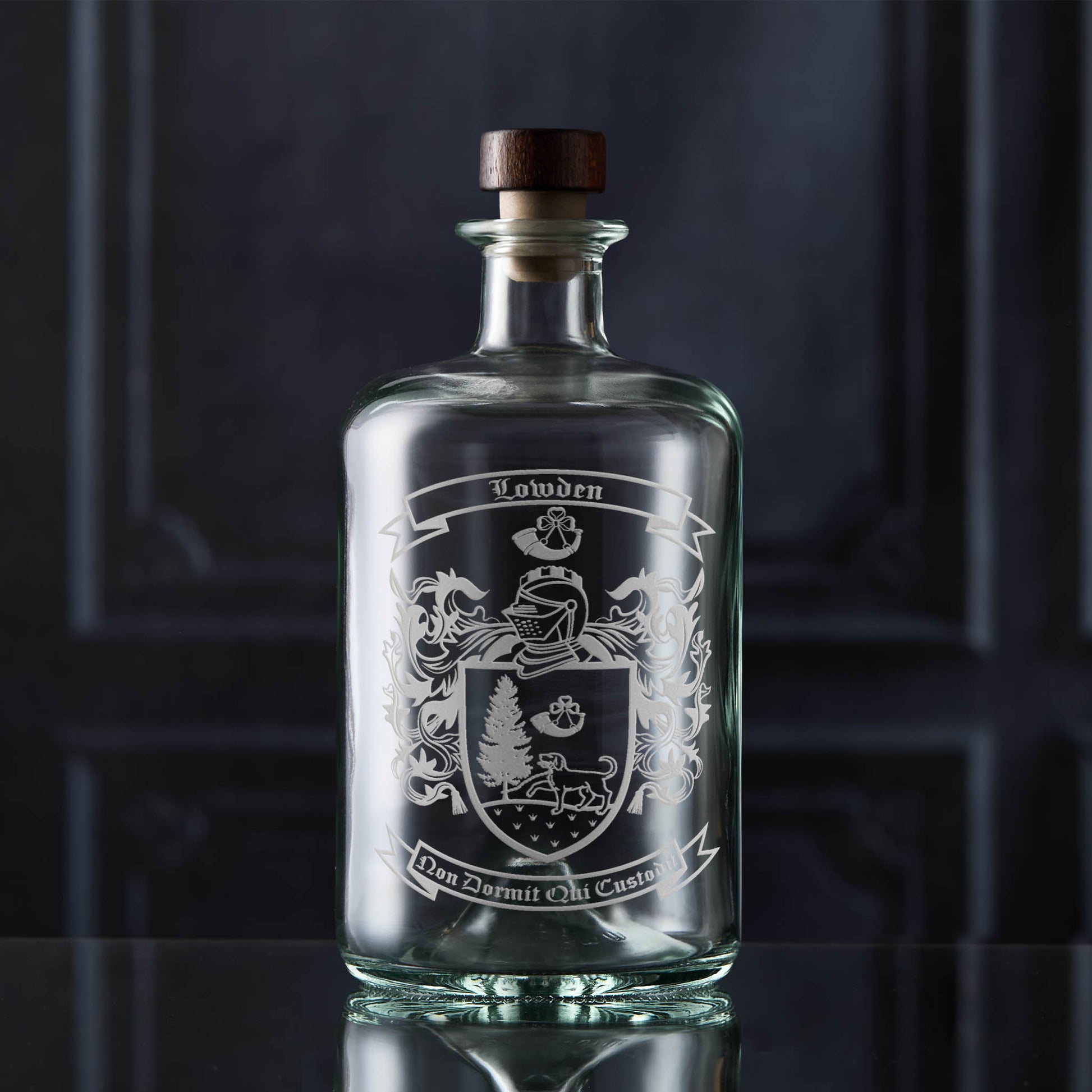 Glass apothecary decanter featuring the a heraldic family crest — crisp, permanent sandblasted detail.