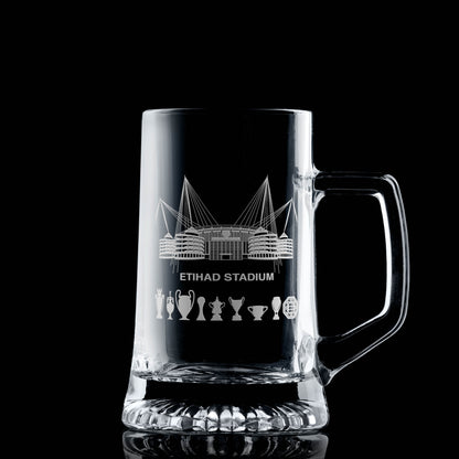 Hand-engraved line-art interpretation of the Etihad Stadium on a glass tankard, with space for personalised message or scoreline.