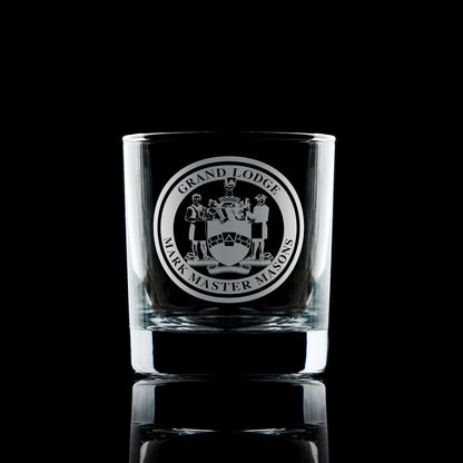 Engraved Mark Master Mason whisky glass with Masonic emblem on black background