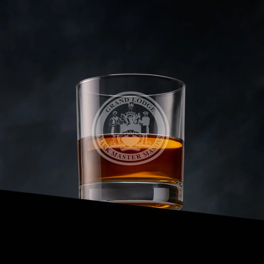 Engraved Mark Master Mason whisky glass with Masonic emblem on black background