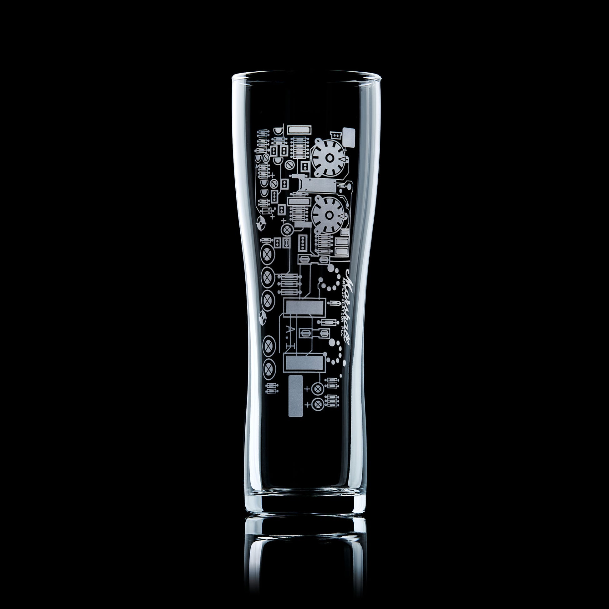 Engraved beer glass with guitar amp circuit board design, shown on a black background.